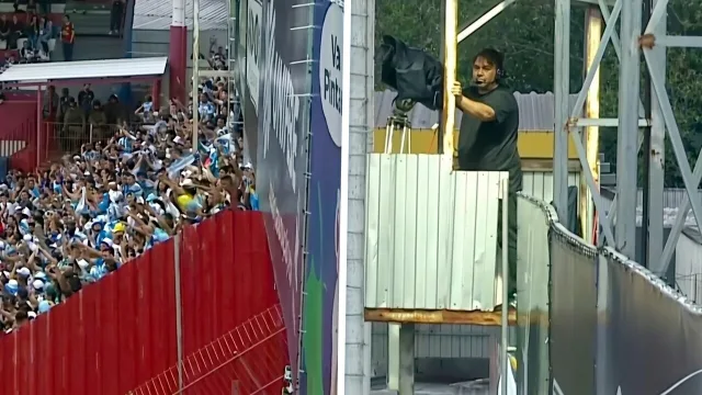 Cameraman houdt zich angstvallig vast terwijl springende supporters zijn platform laten schudden